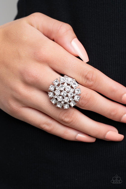 SELFIE-Confidence White Ring - Paparazzi Accessories  Featuring pronged silver fittings, an explosion of glassy white rhinestones sparkles atop the finger for a statement-making fashion. Features a stretchy band for a flexible fit.  Sold as one individual ring.