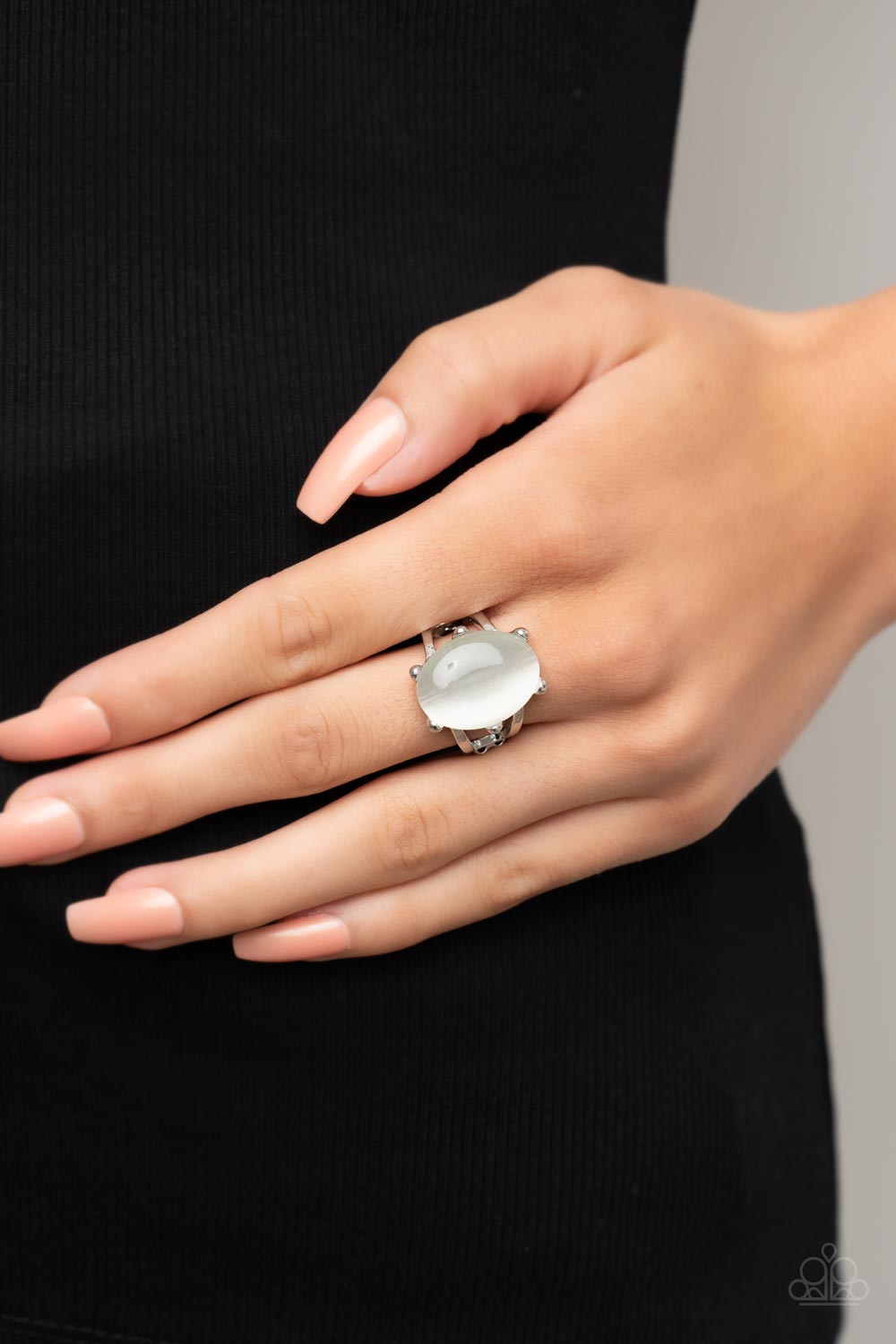 Enchantingly Everglades White Ring - Paparazzi Accessories  An oval white cat's eye gemstone sits atop a pronged silver frame along two layered silver bands, resulting in an enchanting centerpiece atop the finger. Features a stretchy band for a flexible fit.  Sold as one individual ring.