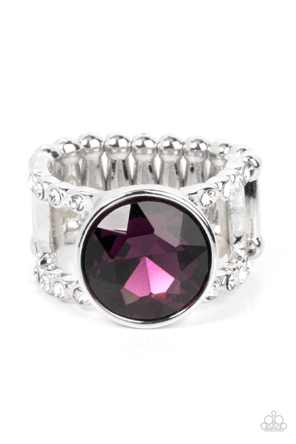 High Roller Sparkle Purple Ring - Paparazzi Accessories  A dramatically oversized brilliant purple solitaire gem, encased in a simple silver frame, sits atop rhinestone encrusted layered bands creating an unapologetically head-turning statement. Features a stretchy band for a flexible fit.  Sold as one individual ring.