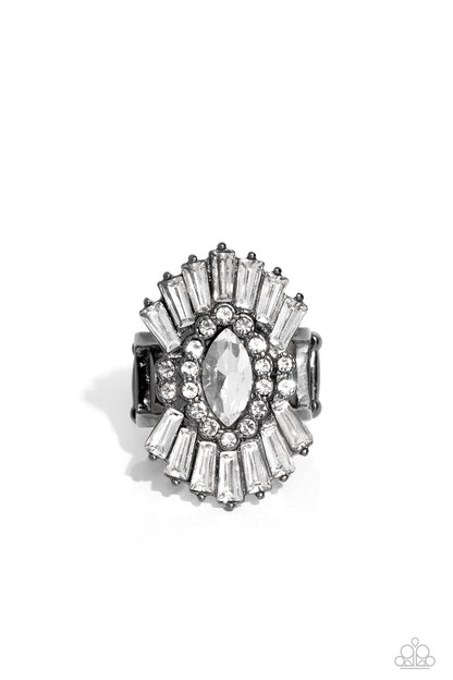 Daringly Deco Black Ring - Paparazzi Accessories   A white, marquise-cut rhinestone is bordered in glassy white rhinestones atop fans of trapezoidal-cut white rhinestones, resulting in an edgy sparkle that explodes atop the finger. Features a stretchy band for a flexible fit.  Sold as one individual ring.