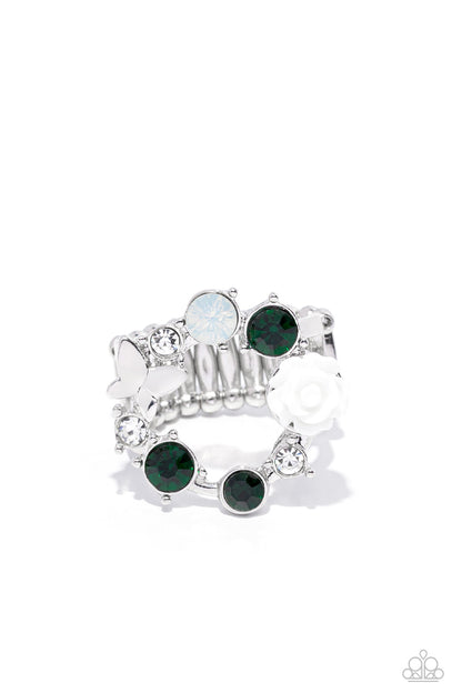 Butterfly Bustle Green Ring - Paparazzi Accessories   A glitzy collection of green, opal, and white rhinestones coalesce into a sparkly wreath atop the finger. Elegantly enhanced with a white resin rosebud, a dainty silver butterfly flutters atop the glittery centerpiece for an enchanting finish. Features a stretchy band for a flexible fit.  Sold as one individual ring.