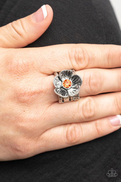 Prismatically Petunia Orange Ring - Paparazzi Accessories  Textured silver petals gently gather around a sparkling orange rhinestone center, blooming into a dazzling floral centerpiece atop the finger. Features a stretchy band for a flexible fit.  Sold as one individual ring.