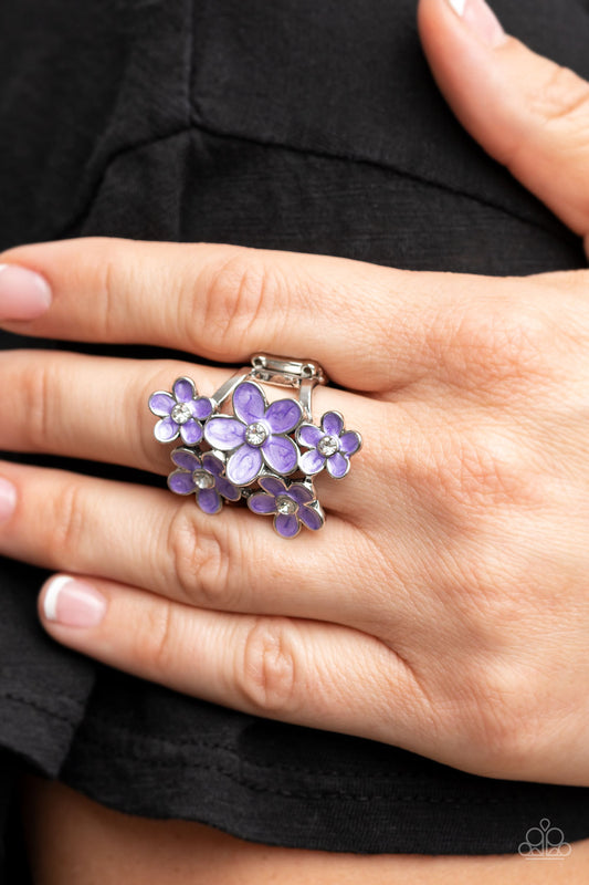 Boastful Blooms Purple Ring - Paparazzi Accessories  Dotted with dainty white rhinestone centers, a bouquet of shiny purple flowers blooms across the finger for a sensational seasonal look. Features a stretchy band for a flexible fit.  Sold as one individual ring.