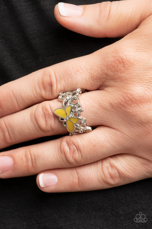 All FLUTTERED Up Yellow Ring - Paparazzi Accessories  Glassy white and iridescent rhinestones are sprinkled across a band of airy silver flowers and a shiny Illuminating butterfly, invoking a whimsical fashion atop the finger. Features a stretchy band for a flexible fit.  Sold as one individual ring.