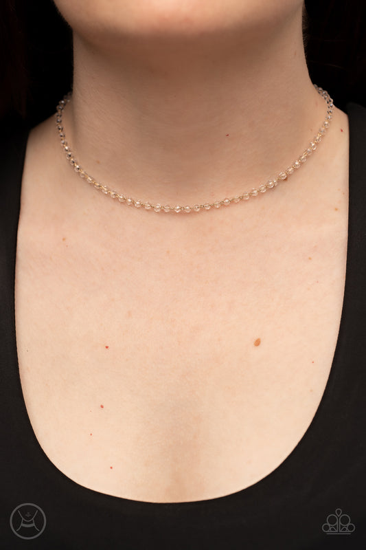 Mini MVP Gold Choker Necklace - Paparazzi Accessories  A dainty row of faceted white crystal-like beads delicately links around the neck, resulting in a golden glimmer. Features an adjustable clasp closure.  Sold as one individual choker necklace. Includes one pair of matching earrings.