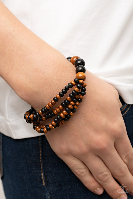 Oceania Oasis Black Bracelet - Paparazzi Accessories  Stretchy strands of dainty brown and black wooden beads attach to a single strand of oversized brown and black wooden beads, resulting in colorful layers around the wrist.  Sold as one individual bracelet.
