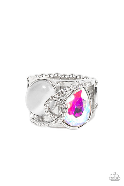 SELFIE-Indulgence Multi Ring - Paparazzi Accessories  A white rhinestone dotted silver ribbon loops and slants over a tilted white cat's eye stone and iridescent teardrop gem, culminating into a stellar centerpiece. Features a stretchy band for a flexible fit.  Sold as one individual ring.