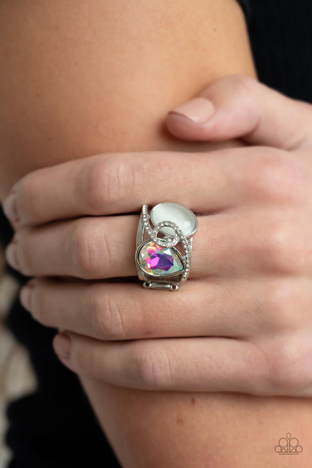 SELFIE-Indulgence Multi Ring - Paparazzi Accessories  A white rhinestone dotted silver ribbon loops and slants over a tilted white cat's eye stone and iridescent teardrop gem, culminating into a stellar centerpiece. Features a stretchy band for a flexible fit.  Sold as one individual ring.