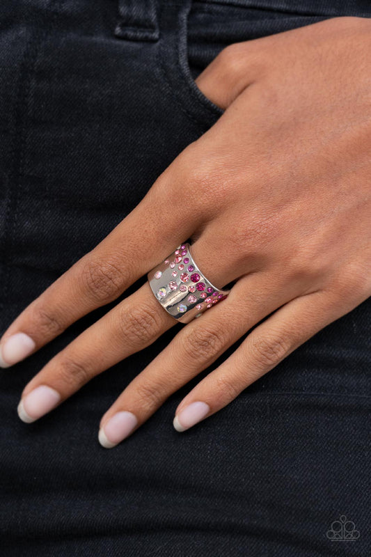 Sizzling Sultry Pink Ring - Paparazzi Accessories  Featuring iridescent and glassy finishes, glitzy rows of pink and multicolored rhinestones are haphazardly sprinkled across the front of a thick silver band for a colorful splash of ombre sparkle. Features a stretchy band for a flexible fit.  Sold as one individual ring.
