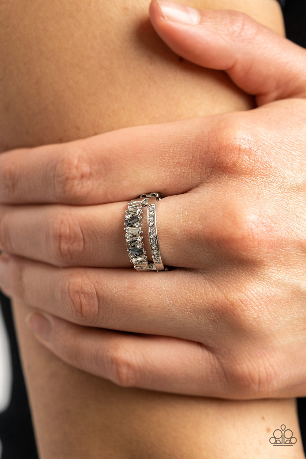 Fractal Fascination Silver Ring - Paparazzi Accessories  Infused with a timeless band of white rhinestones, a dainty collection of trapezoidal cut smoky and white rhinestones staggers across the finger for a glamorously layered look. Features a dainty stretchy band for a flexible fit.  Sold as one individual ring.