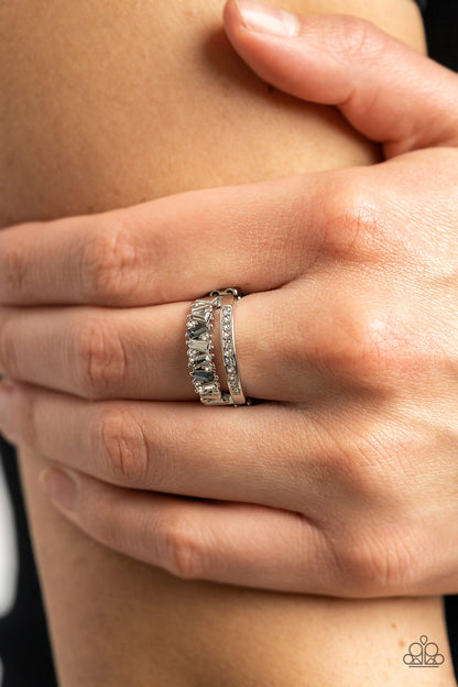 Fractal Fascination Silver Ring - Paparazzi Accessories  Infused with a timeless band of white rhinestones, a dainty collection of trapezoidal cut smoky and white rhinestones staggers across the finger for a glamorously layered look. Features a dainty stretchy band for a flexible fit.  Sold as one individual ring.