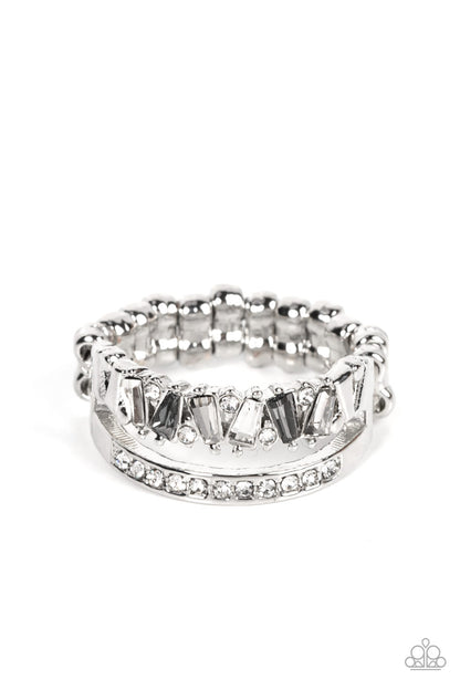 Fractal Fascination Silver Ring - Paparazzi Accessories  Infused with a timeless band of white rhinestones, a dainty collection of trapezoidal cut smoky and white rhinestones staggers across the finger for a glamorously layered look. Features a dainty stretchy band for a flexible fit.  Sold as one individual ring.