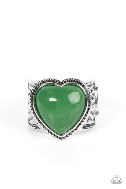 Stone Age Admirer Green Ring - Paparazzi Accessories  A heart shaped jade stone adorns the center of a textured frame atop a thick silver band embossed in indigenous inspired details, resulting in an earthy pop of color atop the finger. Features a stretchy band for a flexible fit.  Sold as one individual ring.