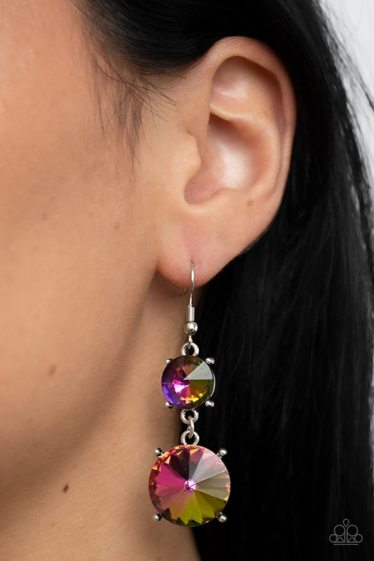 Sizzling Showcase Multi Earring - Paparazzi Accessories  Featuring pronged silver fittings, two oversized oil spill rhinestones dramatically link into a bold smoldering lure as they drip dazzlingly from the ear. Earring attaches to a standard fishhook fitting.  Sold as one pair of earrings.