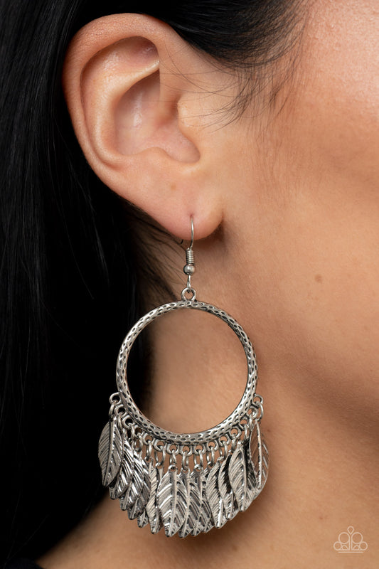 FOWL Tempered Silver Feather Earring - Paparazzi Accessories  Embossed silver feathers dance from the bottom of a hammered silver hoop, resulting into a free-spirited fringe. Earring attaches to a standard fishhook fitting.  Sold as one pair of earrings.