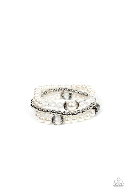 Positively Polished White Bracelet - Paparazzi Accessories  Stretchy pearl and silver beaded bracelets are adorned with ornate silver accents and glassy crystal-like beads, creating polished layers around the wrist.  Sold as one set of three bracelets.