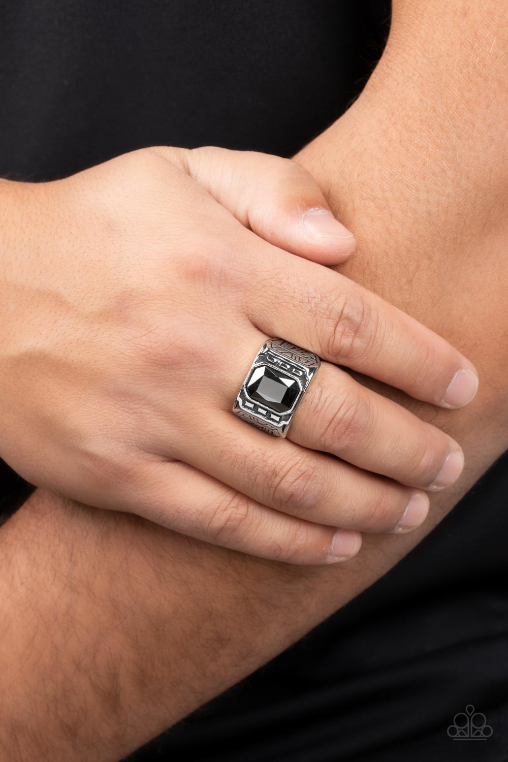 Metro Magnate Silver Urban Ring - Paparazzi Accessories  A majestic emerald cut hematite rhinestone is pressed into the center of a rectangular studded silver frame flanked by geometric texture, creating an edgy centerpiece atop the finger. Features a stretchy band for a flexible fit.  Sold as one individual ring.