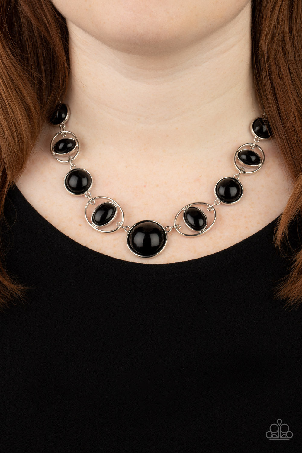 Eye of the BEAD-holder Black Necklace - Paparazzi Accessories  Encased in sleek silver frames, a bubbly collection of oversized black beads alternate with oval black beaded hoops below the collar for a bodacious pop of color. Features an adjustable clasp closure.  Sold as one individual necklace. Includes one pair of matching earrings.