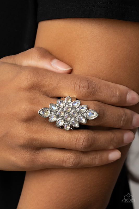 Combustible Iridescence White Ring - Paparazzi Accessories  Round and teardrop iridescent rhinestones fan out across a diamond shaped silver frame, resulting in a stellar centerpiece atop the finger. Features a stretchy band for a flexible fit.  Sold as one individual ring.