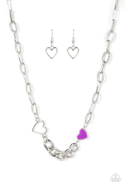 Little Charmer Purple Necklace - Paparazzi Accessories  A pair of shiny silver and purple hearts asymmetrically adorn sections of mismatched silver chain, resulting in a flirtatious pop of color below the collar. Features an adjustable clasp closure.  Sold as one individual necklace. Includes one pair of matching earrings.
