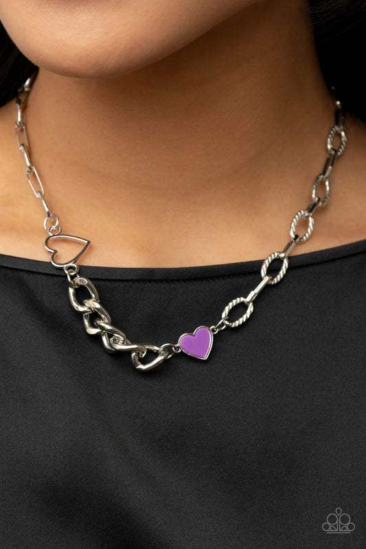 Little Charmer Purple Necklace - Paparazzi Accessories  A pair of shiny silver and purple hearts asymmetrically adorn sections of mismatched silver chain, resulting in a flirtatious pop of color below the collar. Features an adjustable clasp closure.  Sold as one individual necklace. Includes one pair of matching earrings.