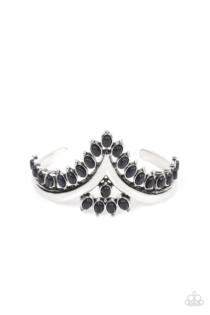 Teton Tiara Black Cuff Bracelet- Paparazzi Accessories   Black oval stones, encased in studded silver frames, line the edge of a daring V-shaped silver cuff. A gathering of black stones adorns the center of the bracelet, adding a finishing touch to the rustically regal cuff.  Sold as one individual bracelet.