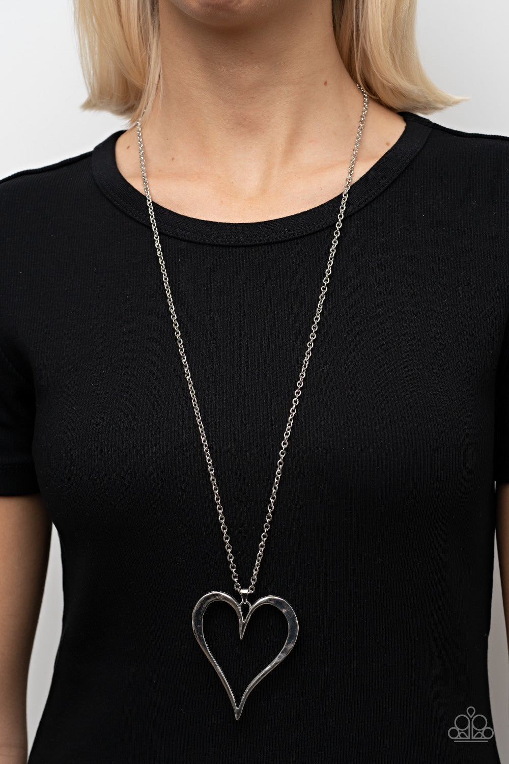 Hopelessly In Love Silver Necklace - Paparazzi Accessories  Featuring subtle hammered details, an oversized silver heart pendant swings from the bottom of a classic silver chain for a rustically romantic shimmer. Features an adjustable clasp closure.  Sold as one individual necklace. Includes one pair of matching earrings.
