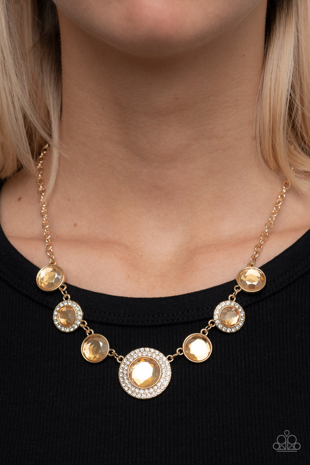 Extravagant Extravaganza - Gold Item #P2RE-GDXX-401XX Oversized golden gems alternate with matching gems bordered in rings of glassy white rhinestones below the collar, resulting in a spellbinding sparkle at the bottom of a classic gold chain. Features an adjustable clasp closure.  Sold as one individual necklace. Includes one pair of matching earrings.