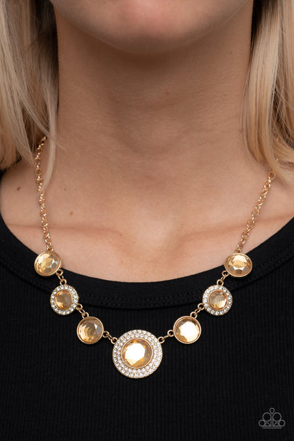 Extravagant Extravaganza - Gold Item #P2RE-GDXX-401XX Oversized golden gems alternate with matching gems bordered in rings of glassy white rhinestones below the collar, resulting in a spellbinding sparkle at the bottom of a classic gold chain. Features an adjustable clasp closure.  Sold as one individual necklace. Includes one pair of matching earrings.
