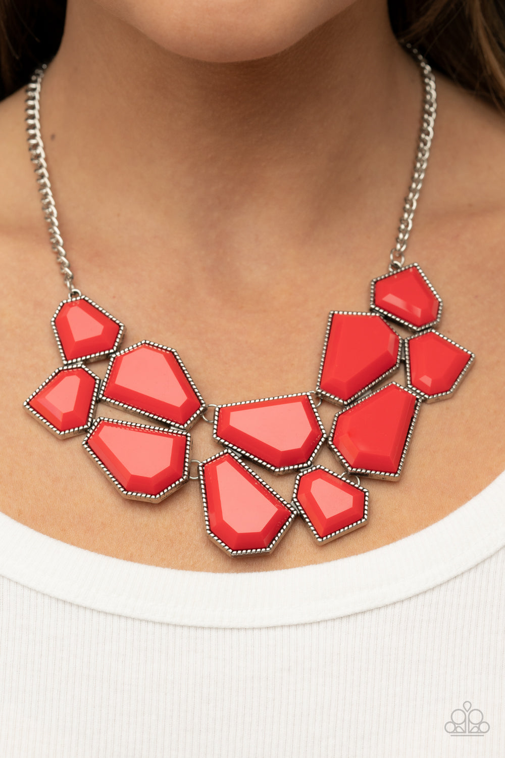 Double-DEFACED - Red Item #P2ST-RDXX-092XX A collection of flamboyant red defaced beads are encased in studded silver frames which link together across the collar. The irregular-shaped designs, suspended from silver chains, make a dynamically striking statement. Features an adjustable clasp closure.  Sold as one individual necklace. Includes one pair of matching earrings.
