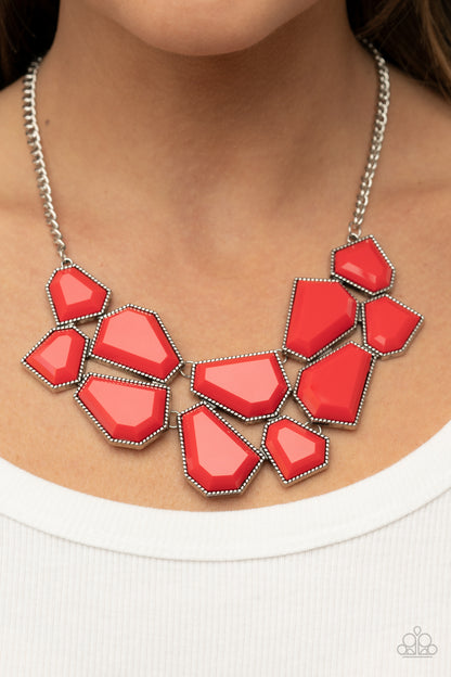 Double-DEFACED - Red Item #P2ST-RDXX-092XX A collection of flamboyant red defaced beads are encased in studded silver frames which link together across the collar. The irregular-shaped designs, suspended from silver chains, make a dynamically striking statement. Features an adjustable clasp closure.  Sold as one individual necklace. Includes one pair of matching earrings.
