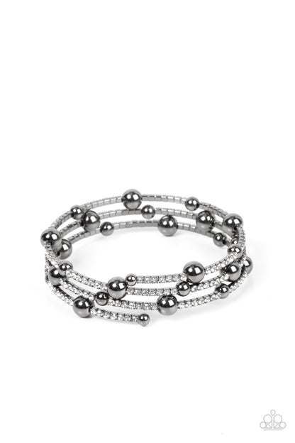 Spontaneous Shimmer Black Bracelet - Paparazzi Accessories  Spontaneously interrupted by glistening gunmetal beads, a sparkly strand of white rhinestones coils around the wrist, resulting in an irresistible infinity wrap bracelet.  Sold as one individual bracelet.