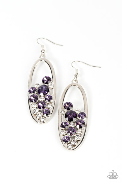 Prismatic Poker Face Purple Earring - Paparazzi Accessories  Effervescent stacks of sparkly white and purple rhinestones bubble up inside a simple silver oval frame creating a prismatically stunning lure. Earring attaches to a standard fishhook fitting.  Sold as one pair of earrings.
