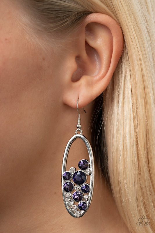 Prismatic Poker Face Purple Earring - Paparazzi Accessories  Effervescent stacks of sparkly white and purple rhinestones bubble up inside a simple silver oval frame creating a prismatically stunning lure. Earring attaches to a standard fishhook fitting.  Sold as one pair of earrings.