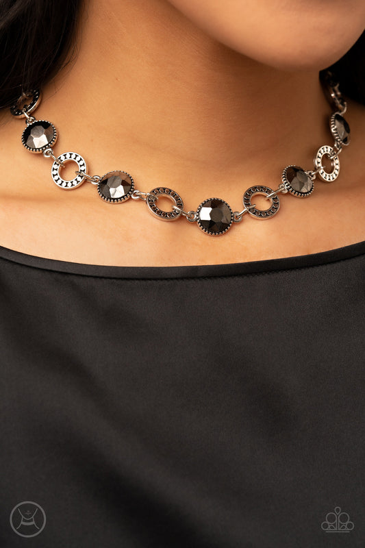 Rhinestone Rollout Silver Choker Necklace - Paparazzi Accessories  Dramatic hematite gems encased in daintily dotted frames link with silver rings finished with flattened studded texture. The stunning rhinestones and edgy rings alternate around the neck, resulting in an upscale industrial flair. Features an adjustable clasp closure.  Sold as one individual choker necklace. Includes one pair of matching earrings.
