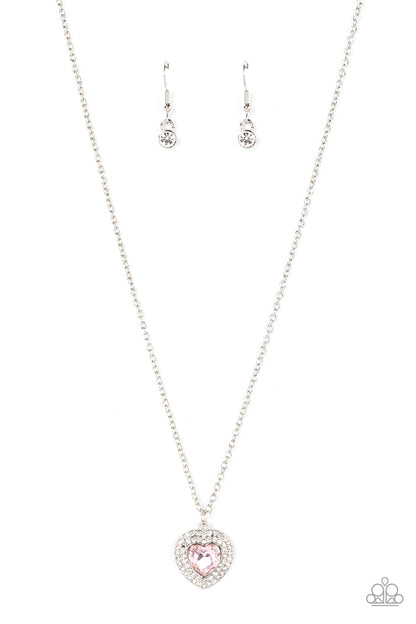 Taken with Twinkle Pink Heart Necklace - Paparazzi Accessories  Bordered in stack rows of glassy white rhinestones, a twinkly pink heart shaped gem sparkles at the center of a dainty silver chain for a flirtatious fashion. Features an adjustable clasp closure.  Sold as one individual necklace. Includes one pair of matching earrings.