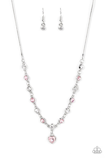 True Love Trinket Pink Necklace & Bracelet Set - Paparazzi Accessories A pink rhinestone heart charm dances from a strand of white and pink rhinestones, resulting in a flirtatious sparkle below the collar and around the wrist. Sold as one individual necklace. Includes one matching bracelet. Get The Complete Look! Bracelet: "Truly Lovely - Pink"