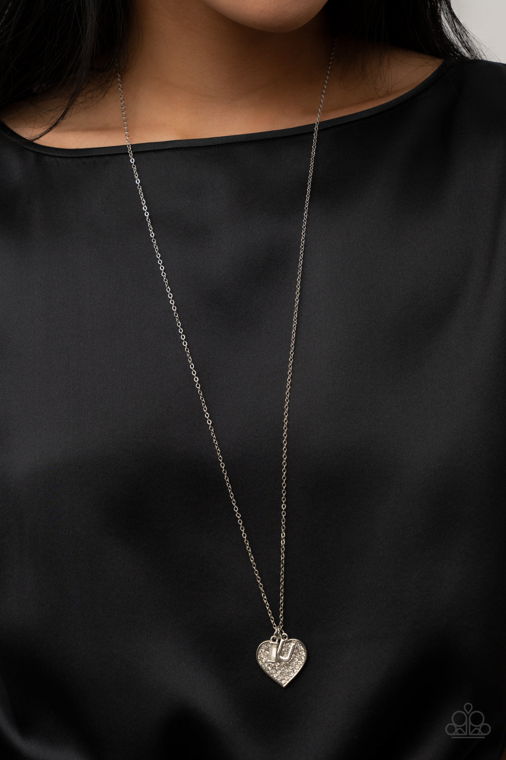 Letters of Love White Necklace & Bracelet Set - Paparazzi Accessories Encrusted with sparkly white rhinestones, an oversized silver heart charm dances between a pair of "I" and "U" charms, resulting in a heartwarming message along a dainty silver chain across the chest and around the wrist. Sold as one individual necklace. Includes one matching bracelet. Get The Complete Look! Bracelet: "Declaration of Love - White"