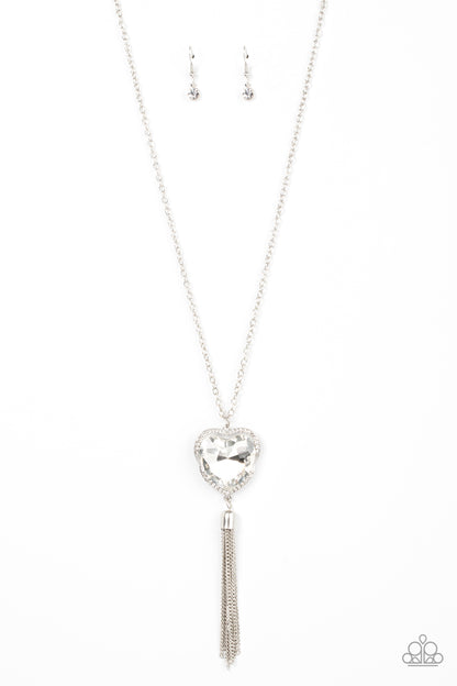 Finding My Forever White Heart Necklace - Paparazzi Accessories  Bordered in a ribbon of glassy white rhinestones, an oversized white heart-shaped gem seemingly floats at the bottom of an extended silver chain. A shimmery silver chain tassel dances from the bottom of the sparkly pendant for a flirtatious finish. Features an adjustable clasp closure.  Sold as one individual necklace. Includes one pair of matching earrings.