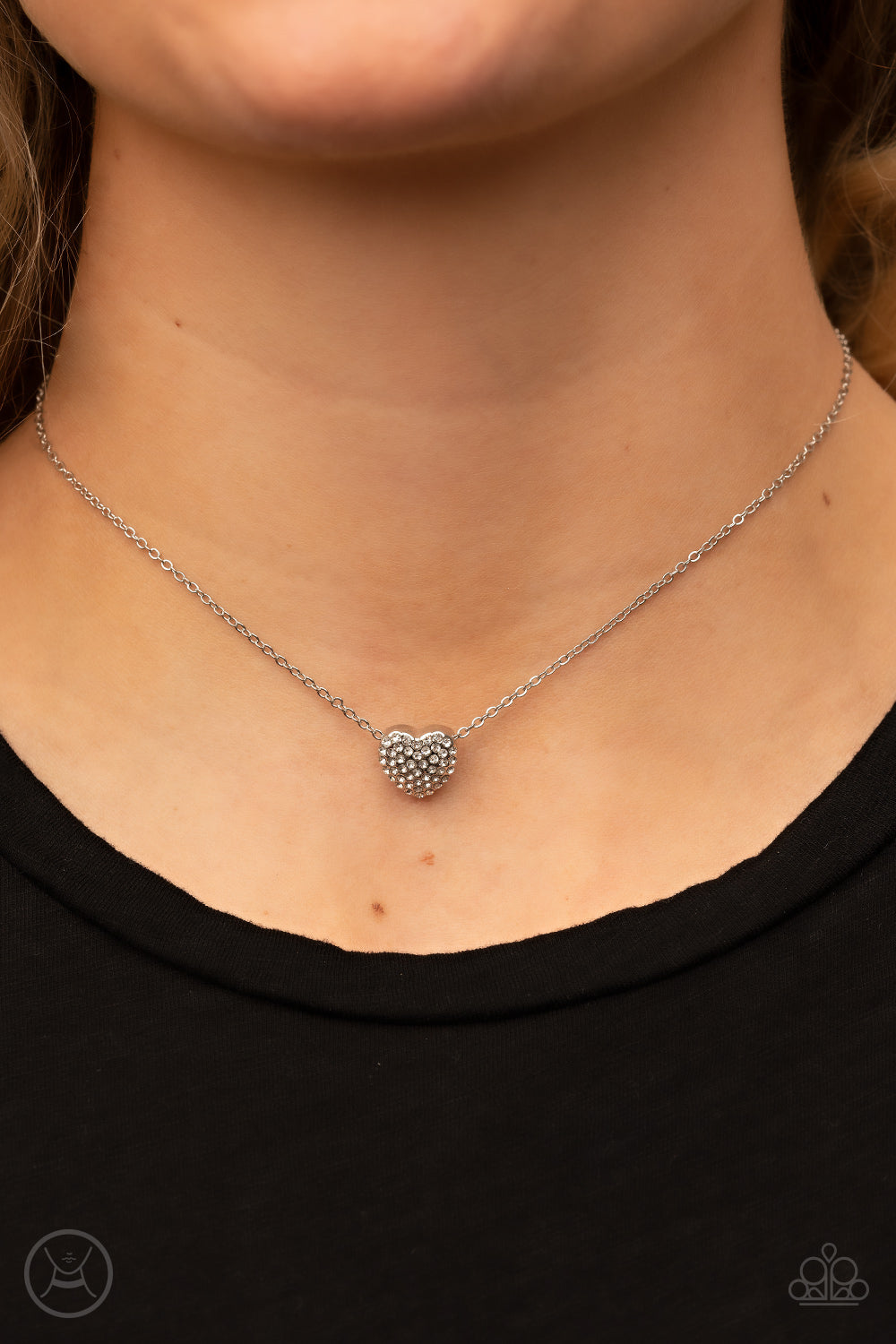 Twitterpated Twinkle White Choker Necklace - Paparazzi Accessories  Encrusted in glassy white rhinestones, a dainty heart frame sparkles along a dainty silver chain around the neck for a flirty finesse. Features an adjustable clasp closure.  Sold as one individual choker necklace. Includes one pair of matching earrings.