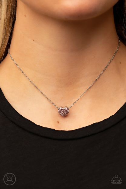 Twitterpated Twinkle Pink Necklace - Paparazzi Accessories  Encrusted in glassy pink rhinestones, a dainty heart frame sparkles along a dainty silver chain around the neck for a flirty finesse. Features an adjustable clasp closure.  Sold as one individual choker necklace. Includes one pair of matching earrings.