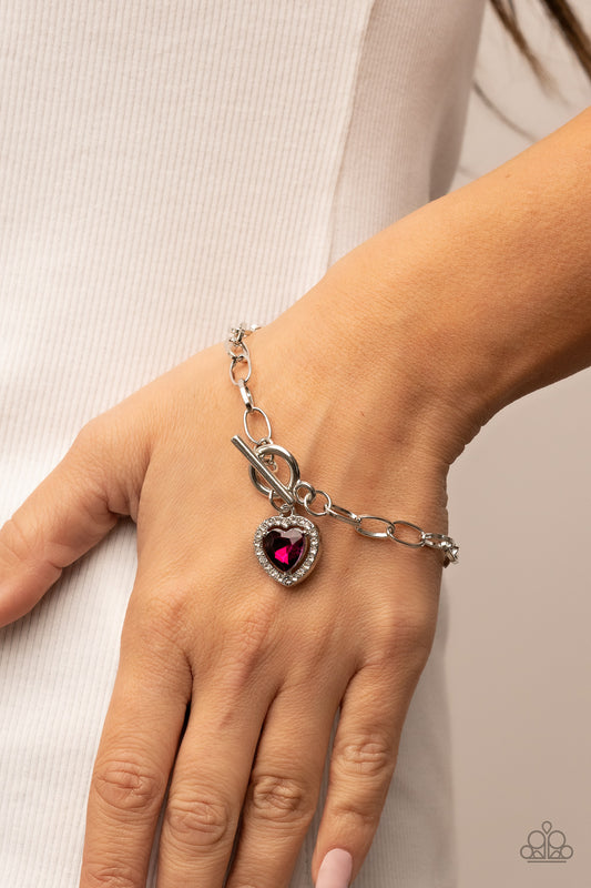 Till DAZZLE Do Us Part Pink Bracelet - Paparazzi Accessories  Bordered in glassy white rhinestones, a pink heart shaped gem sparkles from a toggle closure at the center of an oval silver linked chain for a flirtatious fashion around the wrist. Features a toggle closure.  Sold as one individual bracelet.