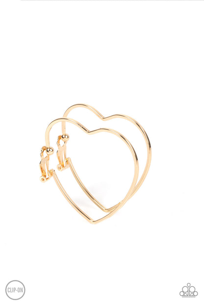 Harmonious Hearts Gold Clip-On Hoop Earring - Paparazzi Accessories  A glistening gold bar delicately curves into an oversized heart frame, resulting in a heart-stopping shimmer. Earring attaches to a standard clip-on fitting.  Sold as one pair of clip-on earrings.