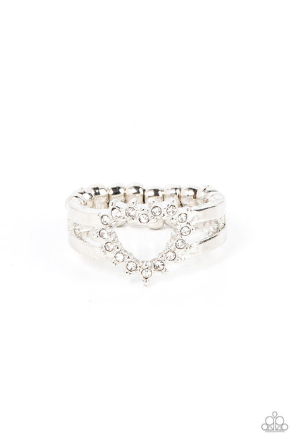 First Kisses White Ring - Paparazzi Accessories  White rhinestone pronged silver fittings coalesce into an airy heart frame atop the center of layered silver frames, resulting in a romantic centerpiece atop the finger. Features a dainty stretchy band for a flexible fit.  Sold as one individual ring.