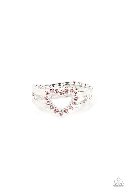 First Kisses Pink Heart Ring - Paparazzi Accessories  Pink rhinestone pronged silver fittings coalesce into an airy heart frame atop the center of layered silver frames, resulting in a romantic centerpiece atop the finger. Features a dainty stretchy band for a flexible fit.  Sold as one individual ring.