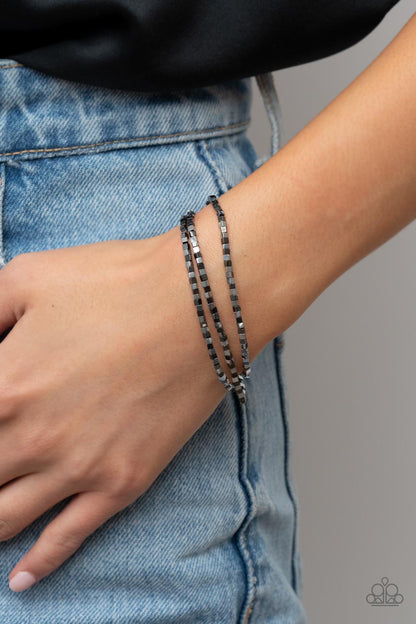 Block Bash Multi Bracelet - Paparazzi Accessories  A dainty collection of silver and gunmetal cube beads alternates along stretchy bands, stacking into edgy layers around the wrist.  Sold as one set of three bracelets.