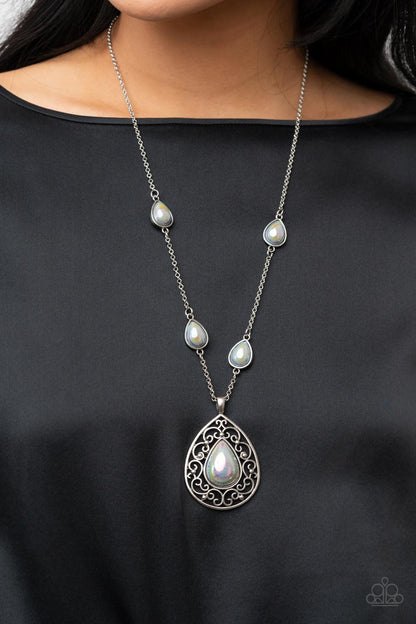 Magical Masquerade Silver Necklace - Paparazzi Accessories  Brushed in an iridescent finish, a silvery teardrop bead is pressed into the center of an oversized silver teardrop frame that is bursting with vine-like filigree. Infused with matching teardrop beaded frames, the ethereal pendant glides along the beaded silver chain for a magical finish. Features an adjustable clasp closure.  Sold as one individual necklace. Includes one pair of matching earrings.