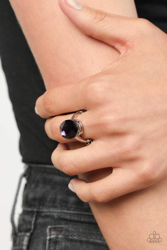 Updated Dazzle Purple Ring - Paparazzi Accessories  A stunning faceted plum gem, set in edgy pronged fittings, creates a glamorous show-stopping centerpiece atop sleek silver bands. Features a dainty stretchy band for a flexible fit.  Sold as one individual ring.