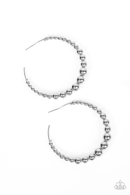 Show Off Your Curves Silver Hoop Earring - Paparazzi Accessories  Gradually increasing in size, shiny silver beads are threaded along an oversized silver hoop for a gritty and glamorous effect. Earring attaches to a standard post fitting. Hoop measures approximately 2 1/2" in diameter.  Sold as one pair of hoop earrings.