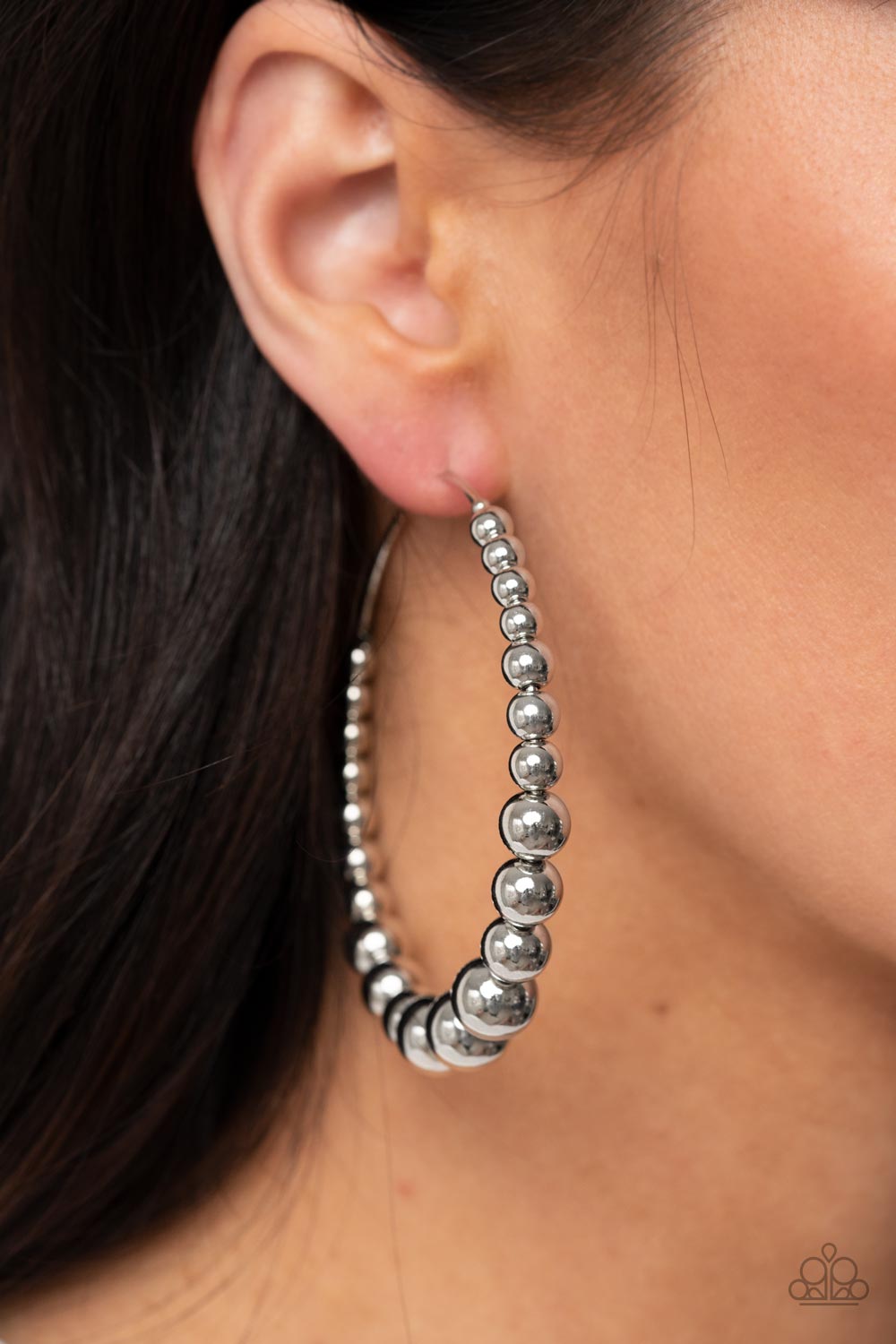 Show Off Your Curves Silver Hoop Earring - Paparazzi Accessories  Gradually increasing in size, shiny silver beads are threaded along an oversized silver hoop for a gritty and glamorous effect. Earring attaches to a standard post fitting. Hoop measures approximately 2 1/2" in diameter.  Sold as one pair of hoop earrings.